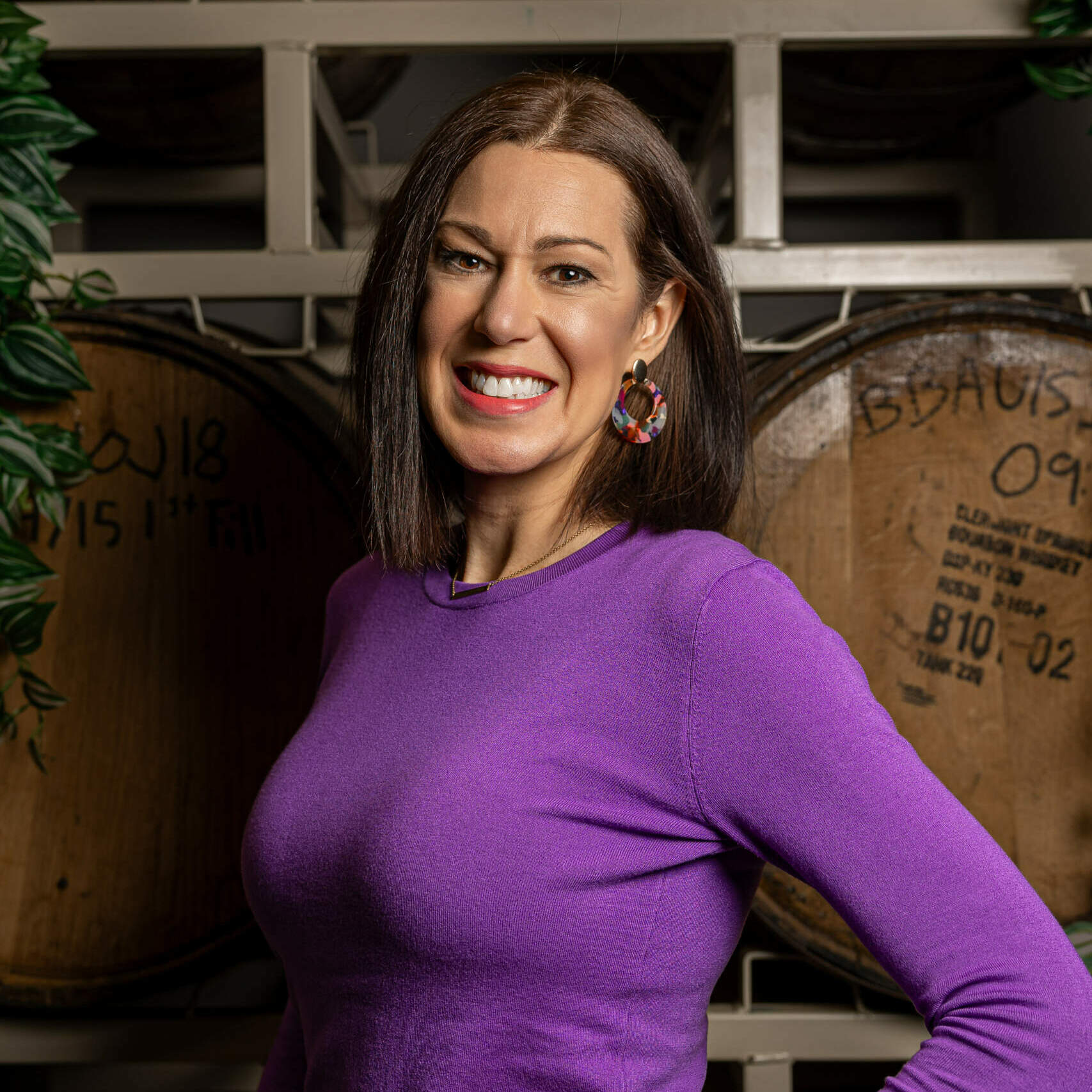 Headshot of a woman smiling with one hand on her hip